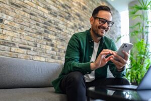 Man holding phone shows the ease of mobile access control