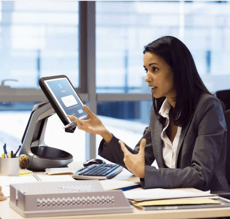 Banking worker speaking next to secure tablet stand