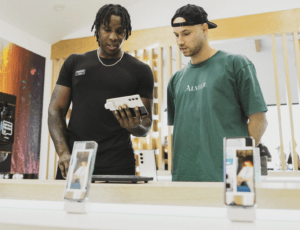 Handling a smartphone on a security display at a Samsung store