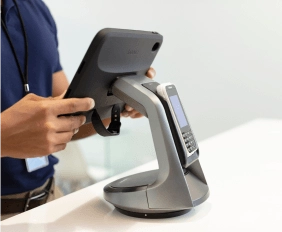 Hand putting in an order on a tablet stand