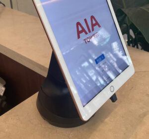 White tablet on black tablet stand in AIA Tower
