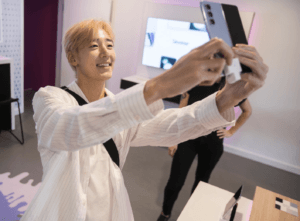 Handling a smartphone on a security display at a Samsung store
