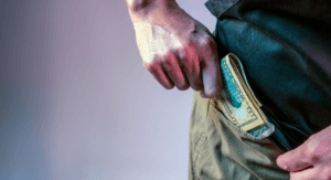 Cash being placed in a pocket