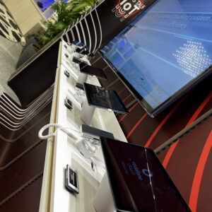 White table with mobile devices on security stands