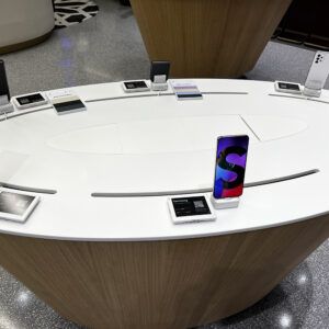 White table with mobile devices on security stands