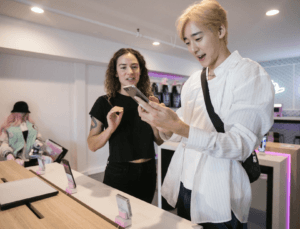 Two people holding a Samsung phone