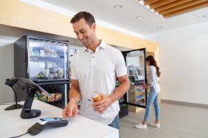 Man at counter making payment at mobile payment system