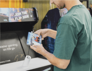 Man holding a game secured by an InVue device