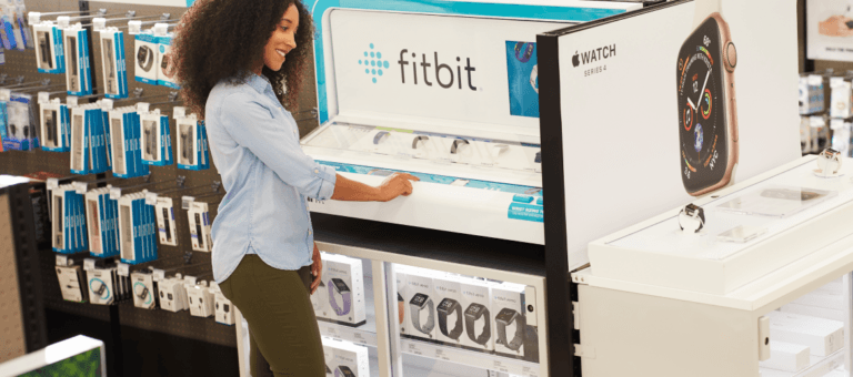 Woman at Fitbit Display in retail store