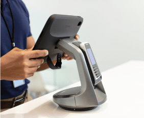 Hand putting in an order on a tablet stand