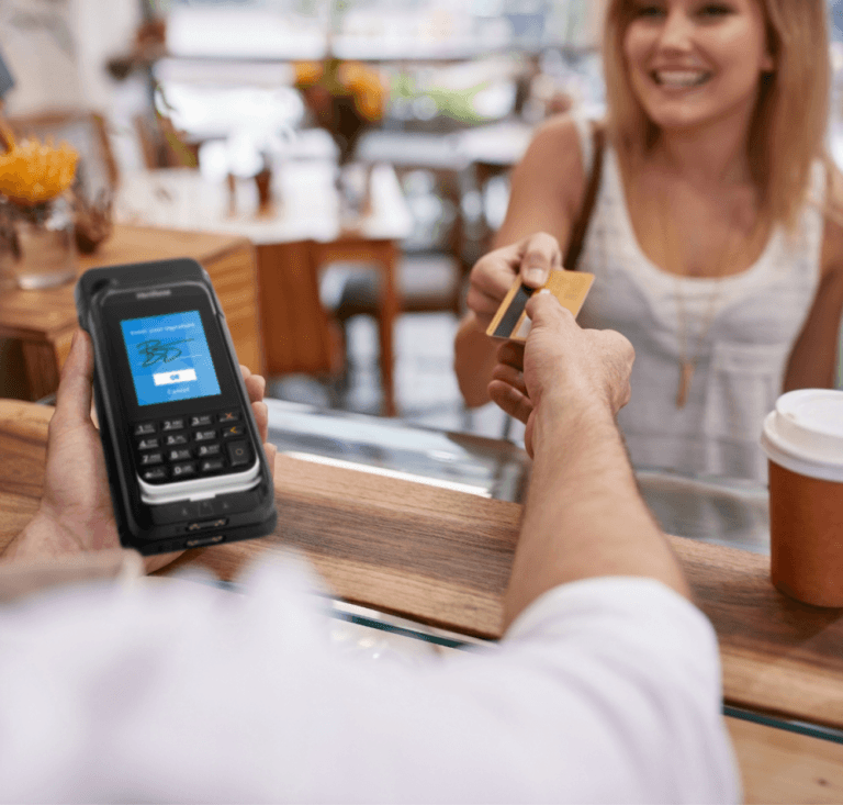 Woman handing credit card to a worker holding a mPOS