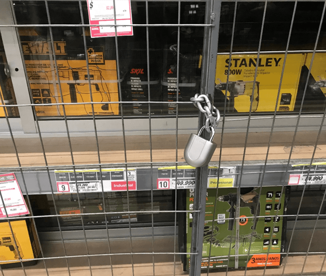 Padlock securing cage with Stanley and DeWalt tools