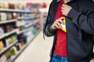 Man attempting to steal product in jacket