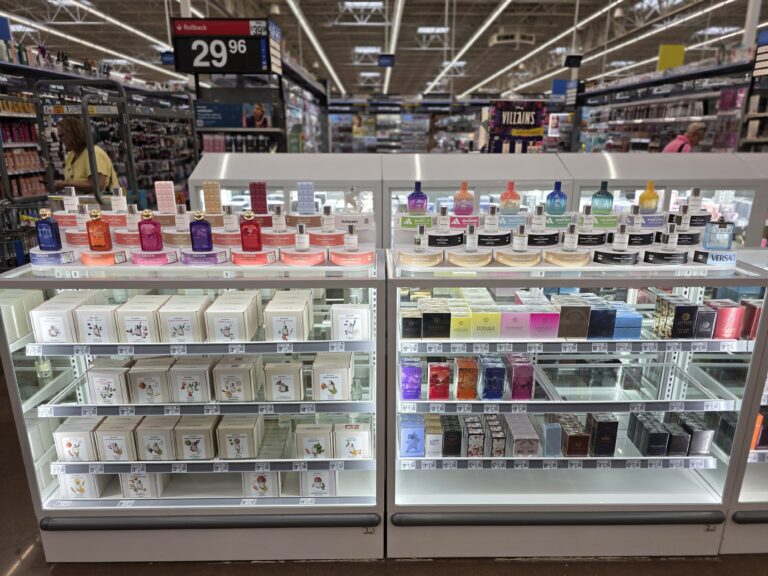 glass display securing stock of perfume boxes, and tester displays sitting on top of it where the customer can interact with the fragrances.