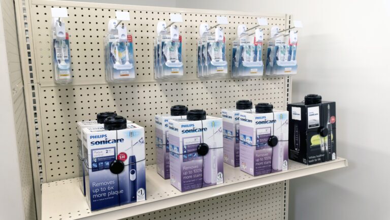 Health products like electronic toothbushes or electronic razors in boxes secured by security solutions.
