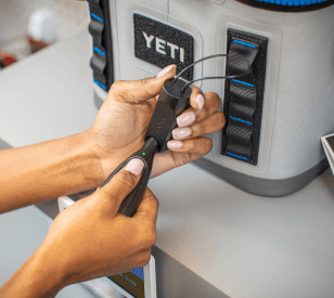 OneKEY unlocking a cable lock anchor secured to a Yeti cooler