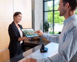 Man and woman holding a NE150 Convertible POS Stand