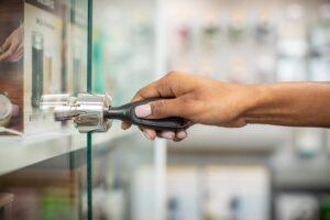 Hand using a OneKEY to open a Lock on a display case