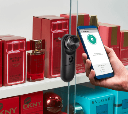 Smart Lock being unlocked by a phone on a perfume case with glass doors