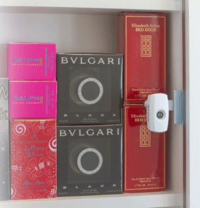 Cam Lock on swing-out glass door protecting boxes of perfume