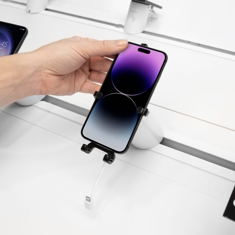 Someone removing a phone from a quick-release bracket.