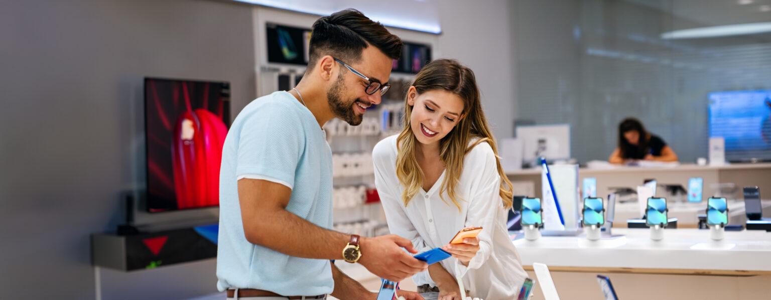 Man and woman shopping for smartphones