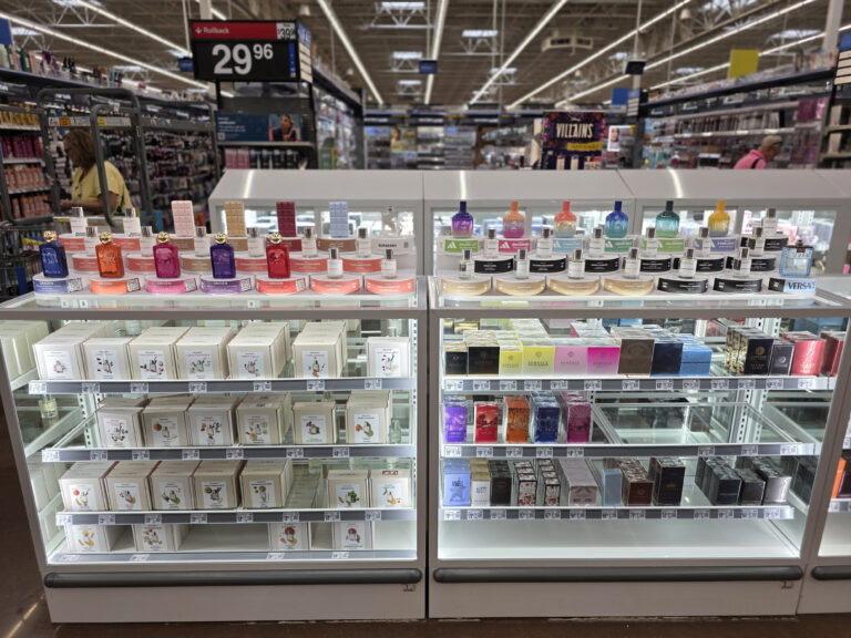 glass display securing stock of perfume boxes, and tester displays sitting on top of it where the customer can interact with the fragrances.